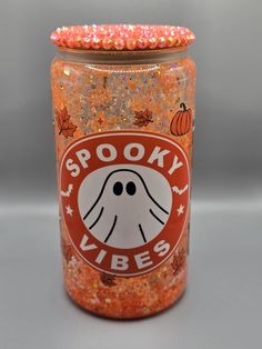 an orange spooky vibes jar filled with candy