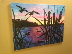 a painting of ducks flying over the water at sunset with reeds in foreground