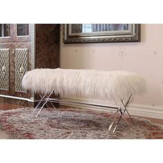 a white bench sitting on top of a rug in a living room next to a mirror