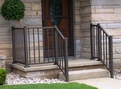 the front door of a house with metal railings