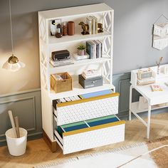 a white book shelf filled with books next to a desk and chair in a room