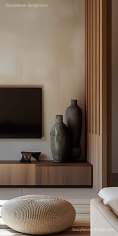 a living room with a large flat screen tv on top of a wooden entertainment center