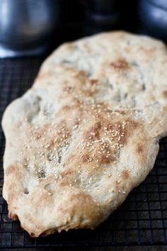 an uncooked piece of bread sitting on top of a cooling rack