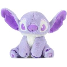 a purple stuffed animal sitting on top of a white surface