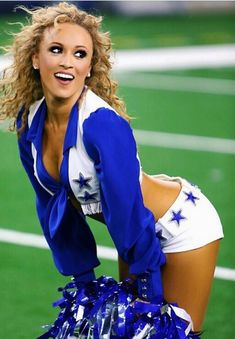 a cheerleader is posing on the field with her blue and white pom - poms