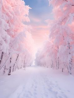 a snow covered road surrounded by pink trees