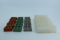 several different colored blocks and bricks on a white surface