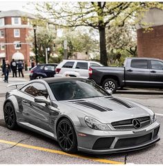 the mercedes sls amg is parked on the street