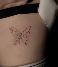 a woman with a butterfly tattoo on her stomach