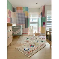 a child's room with colorful walls and rugs