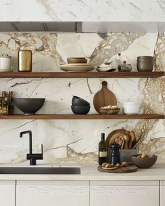 the shelves in this kitchen are filled with dishes and bowls, along with wine bottles