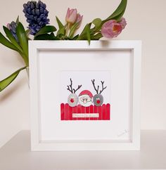 there is a picture of two reindeers in a red sleigh with flowers