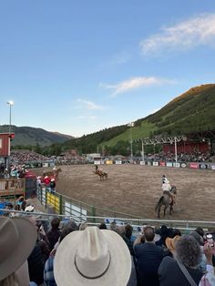 a man riding on the back of a horse at a rodeo