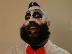 a man with his face painted to look like it is wearing a hat and bow tie