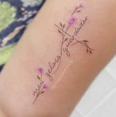 a woman's thigh with the word, love and flowers tattooed on it