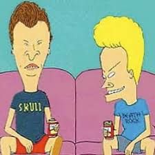 two people sitting on a couch with cans of sodas in front of their faces