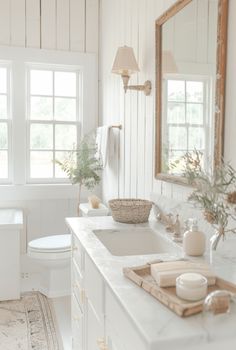 Farmhouse bathroom ideas blend rustic charm with modern comforts. Utilize natural materials like wood and stone, White Farmhouse Bathroom, Modern Farmhouse Bathroom Ideas, White Modern Farmhouse, Farmhouse Bathroom Ideas, Farmhouse Bathroom Design, Rustic Wooden Bench, Farmhouse Glam, White Shiplap Wall, Natural Bathroom