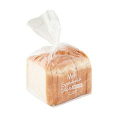 a loaf of white bread wrapped in plastic on a white background with the words milk sandwhich written above it