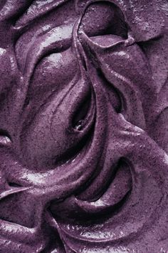 a close up view of purple paint that looks like it has been swirled in the wind