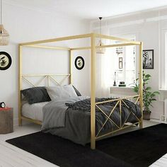 a bedroom with white walls, black and gold bedding and rugs on the floor