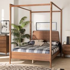 a bedroom with a four poster bed and wooden furniture