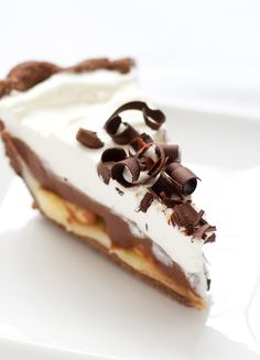 a piece of chocolate and cream pie on a white plate