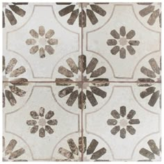 a white and brown tile with flowers on it