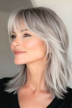 Save this pin for the best shag hairstyles for women over 50. Silvery shades paired with a layered shag create a youthful, stunning style. The bangs gently sweep across the forehead, offering a soft frame. Gray Hair 50 Years Old, Long Layered Gray Hair Over 50, Over Fifty Hairstyles Over 50, Long Blonde Bob With Bangs, Growing Out Bangs Hairstyles Over 50, Medium Grey Hair Over 50, Layered Grey Hair, Gray Shag Hairstyles, Bangs Grey Hair