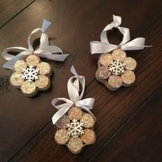 three ornaments with bows and snowflakes on them