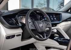 the interior of a car with steering wheel and dashboard