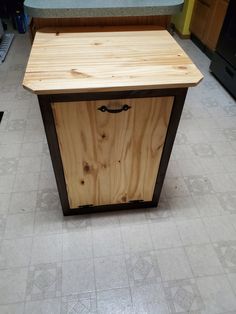 a kitchen island made out of plywood with a drawer on the front and bottom