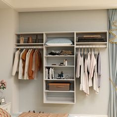 an organized closet with clothes hanging on shelves