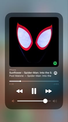 an iphone screen with the music player on it's side, and two red eyes