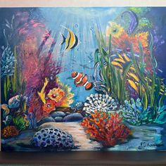 an underwater scene with fish and corals painted on the side of a building wall