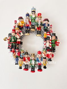 a wreath made out of nutcrackers and other toy figurines on a white background