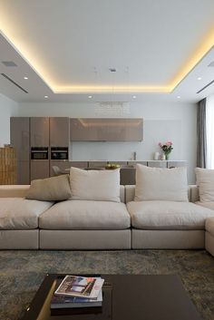 a living room filled with furniture and a flat screen tv mounted to the side of a wall