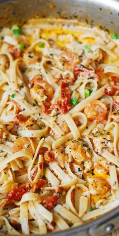 a pan full of pasta with shrimp and sauce