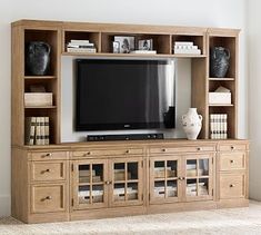 a large entertainment center with bookshelves and a flat screen tv