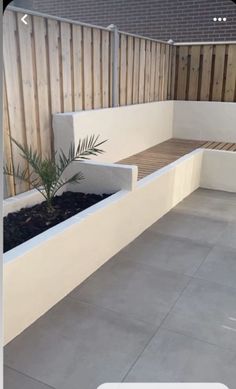 a small garden area with plants and benches