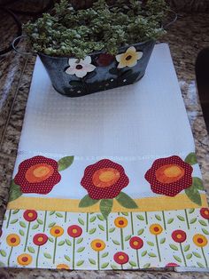 a potted plant sitting on top of a counter next to a white table cloth