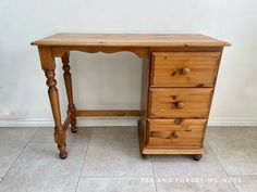 a wooden desk with two drawers on it