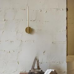 an old typewriter sitting in front of a white wall with a clock on it