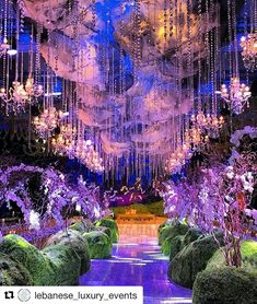 an elaborately decorated garden with chandeliers hanging from the ceiling and lush greenery