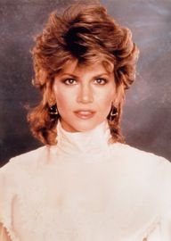 a woman in a white dress posing for a photo with her hair up and wearing large earrings