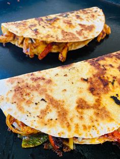 two quesadillas sitting on top of a pan