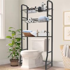 a bathroom with a white toilet and black metal shelving unit on top of it