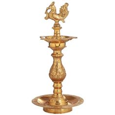 a gold colored fountain with a bird on top