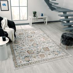 a living room with a rug and stairs