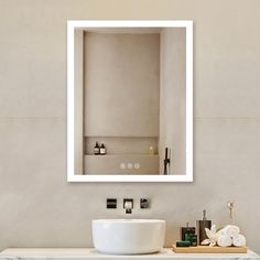 a bathroom with a sink, mirror and soap dispenser on the counter