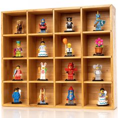 a wooden shelf filled with lots of toy figurines on top of each other